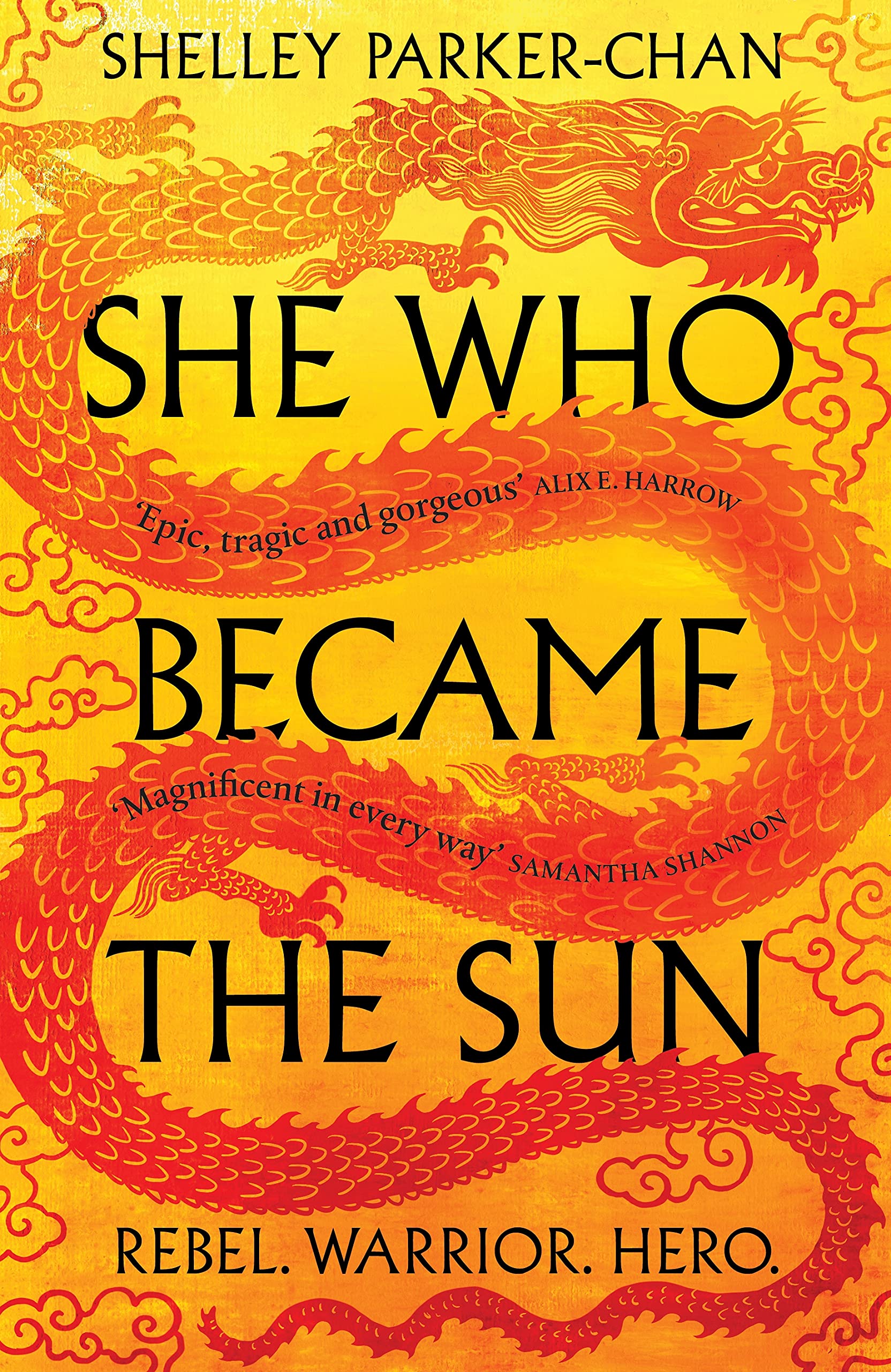 The UK cover of She Who Became the Sun. A Yellow-orange background with a deeper orange gradient. A print of a scarlet imperial dragon curves around the title, with swirling smoke all over the cover.